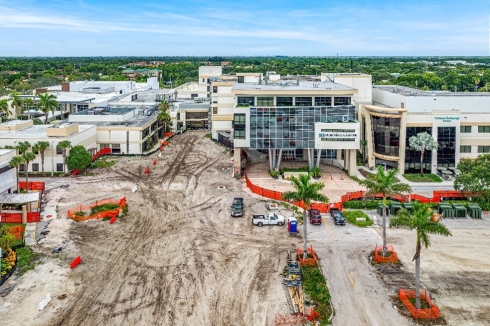 A building under construction with trees and a road
Description automatically generated